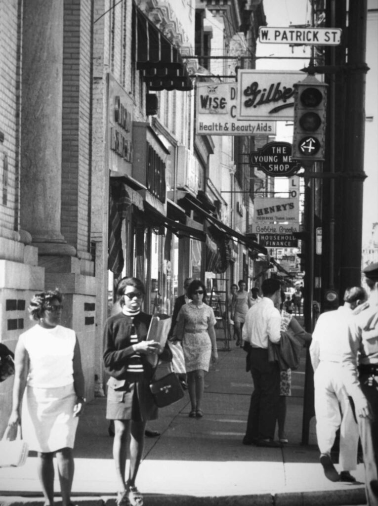 Black and white photo of a busy sidewalk in Frederick, Maryland during the 50's